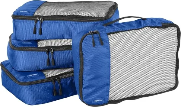 Blue 4-piece packing cubes set for travel, medium size. Zipper organizers for efficient suitcase packing and space-saving during trips.