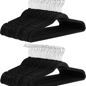 Amazon Basics 100-pack slim velvet hangers with silver metal hooks and a black finish. Non-slip design ensures clothes stay in place for an organized closet.