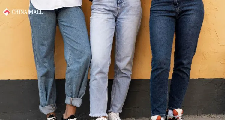 Stylish woman wearing light blue baggy jeans with white top walking through modern Dubai mall, showcasing comfortable loose-fit denim fashion trends 2025