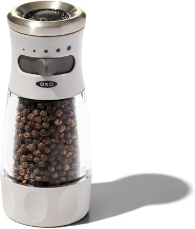Manual pepper grinder with ceramic burr and adjustable grind settings, featuring a mess-free contour design.