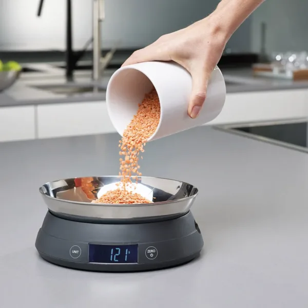 This grey Joseph Joseph digital kitchen scale features a reversible lid that transforms into a bowl for easy measuring of loose ingredients and liquids.
