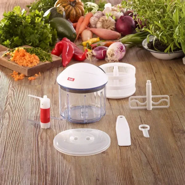 This is a Fissler finecut vegetable chopper with a pull mechanism, designed for slicing onions and other vegetables, and it comes with dishwasher-safe parts.