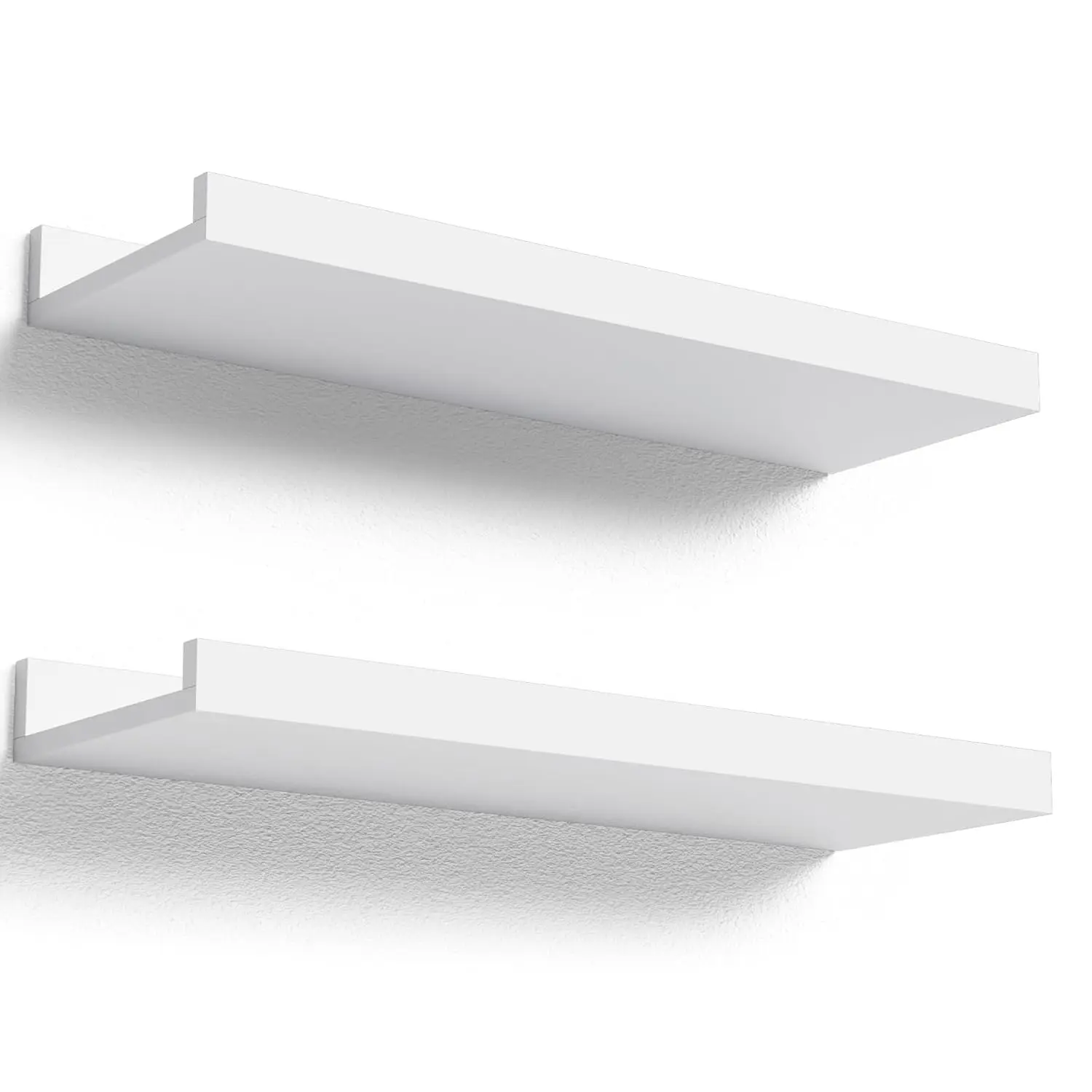 This set of two white floating shelves with a front lip provides sturdy and stylish wall-mounted storage for displaying pictures, books, plants, and decorative items in any room.
