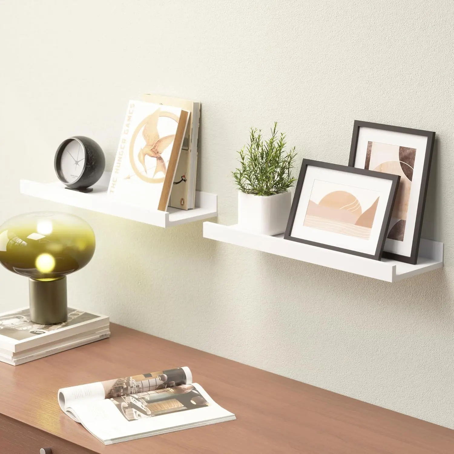 This set of two white floating shelves with a front lip provides sturdy and stylish wall-mounted storage for displaying pictures, books, plants, and decorative items in any room.
