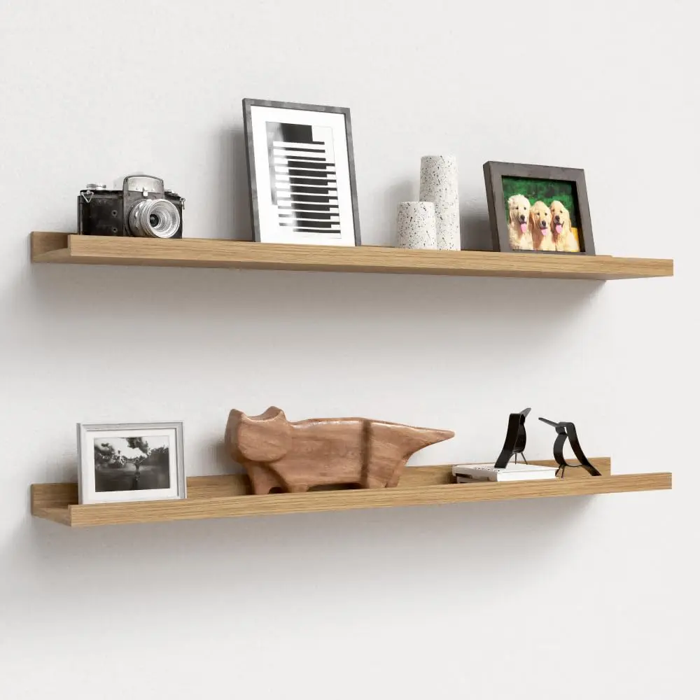 This set of two white floating shelves with a front lip provides sturdy and stylish wall-mounted storage for displaying pictures, books, plants, and decorative items in any room.