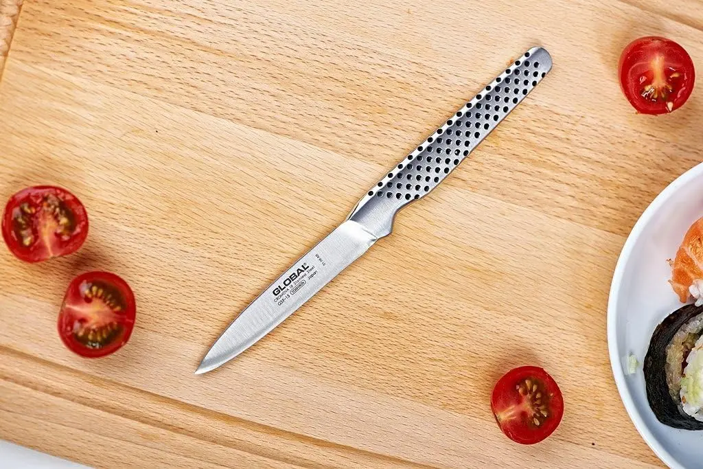 This is a Global paring knife with an 8cm stainless steel blade and a dimpled, ergonomic handle, handcrafted in Japan for excellent balance and precision.