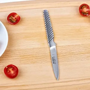 This is a Global paring knife with an 8cm stainless steel blade and a dimpled, ergonomic handle, handcrafted in Japan for excellent balance and precision.