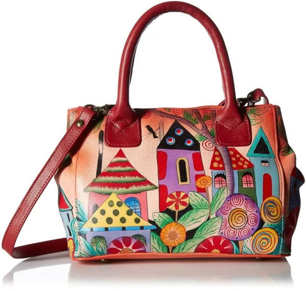 This Anna by Anuschka hand-painted leather tote bag features a village of dreams artwork, a double short handle, and a removable crossbody strap for versatile carrying options.