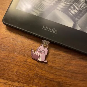 This 7-pack of bookish cat USB-C dust plugs protects your Kindle, iPhone 15, and other devices from dust and dirt while adding a charming touch.
