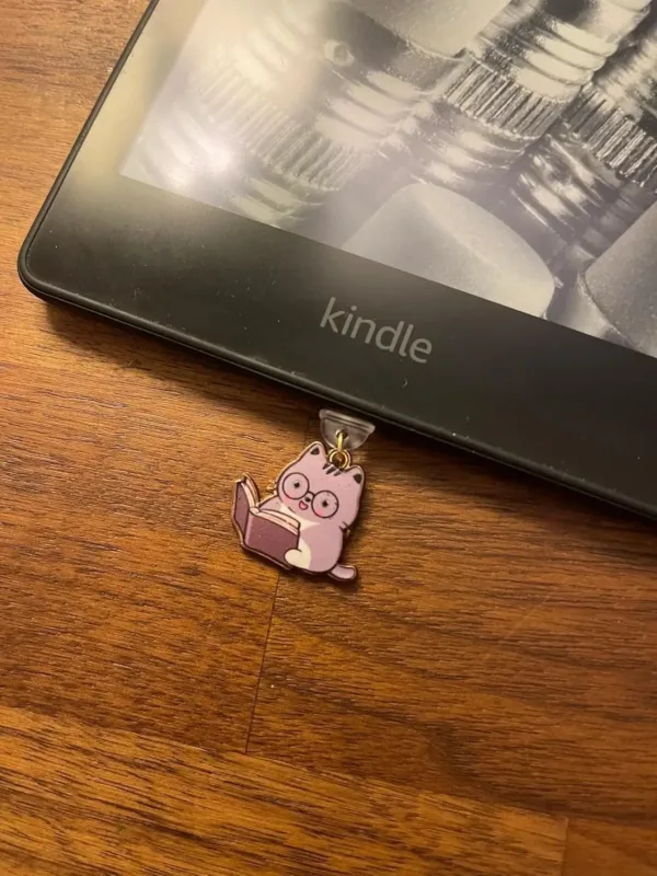 This 7-pack of bookish cat USB-C dust plugs protects your Kindle, iPhone 15, and other devices from dust and dirt while adding a charming touch.
