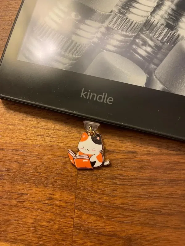 This 7-pack of bookish cat USB-C dust plugs protects your Kindle, iPhone 15, and other devices from dust and dirt while adding a charming touch.