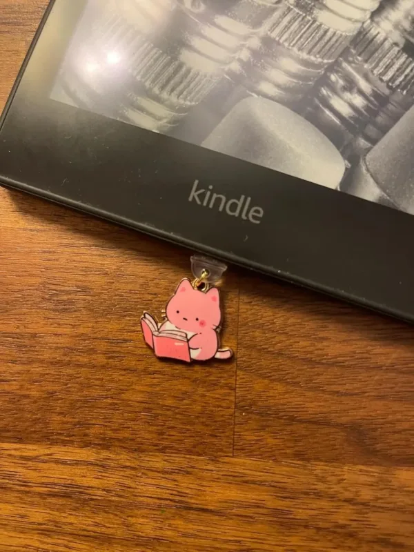This 7-pack of bookish cat USB-C dust plugs protects your Kindle, iPhone 15, and other devices from dust and dirt while adding a charming touch.