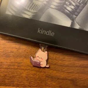 This 7-pack of bookish cat USB-C dust plugs protects your Kindle, iPhone 15, and other devices from dust and dirt while adding a charming touch.