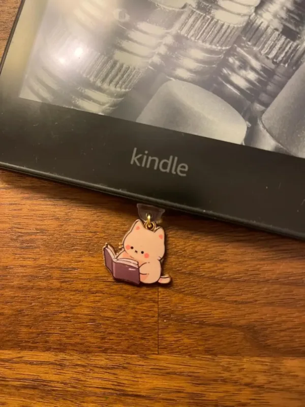This 7-pack of bookish cat USB-C dust plugs protects your Kindle, iPhone 15, and other devices from dust and dirt while adding a charming touch.