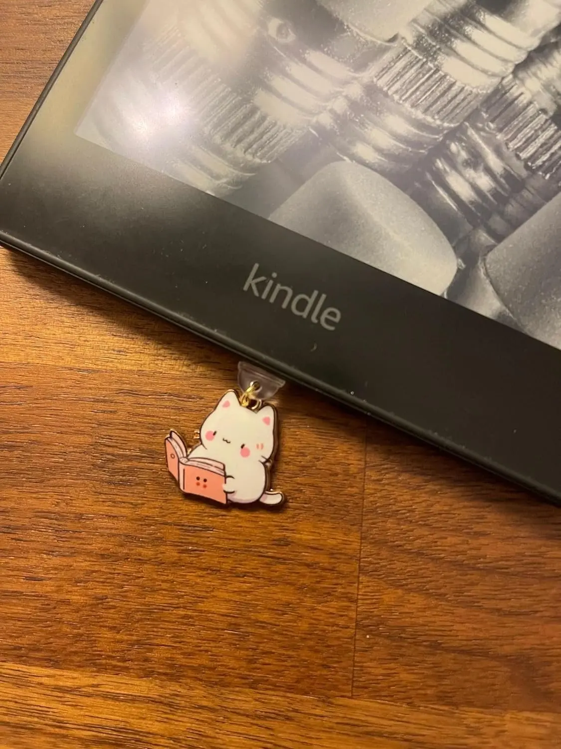 This 7-pack of bookish cat USB-C dust plugs protects your Kindle, iPhone 15, and other devices from dust and dirt while adding a charming touch.