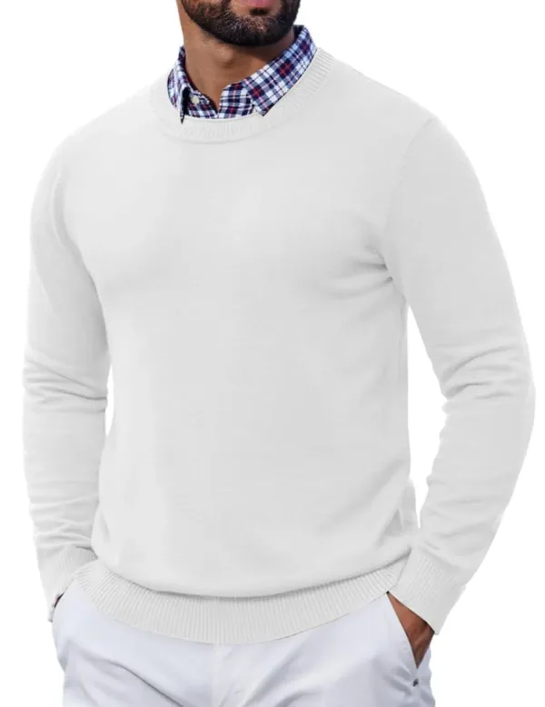 A man wearing a slim fit, solid color COOFANDY crewneck knit sweater with ribbed hem and cuffs, perfect for layering or wearing alone in cool weather.