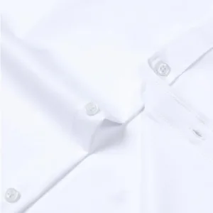 A wrinkle-free slim fit dress shirt for men, made from slightly shiny, elastic polyester-spandex fabric, featuring long sleeves and a comfortable wider waist.