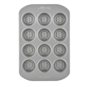 Bake delicious mini muffins with ease using the Prestige 12-cup muffin tin, featuring a nonstick surface, durable carbon steel construction, and a honeycomb base for even browning and easy release.