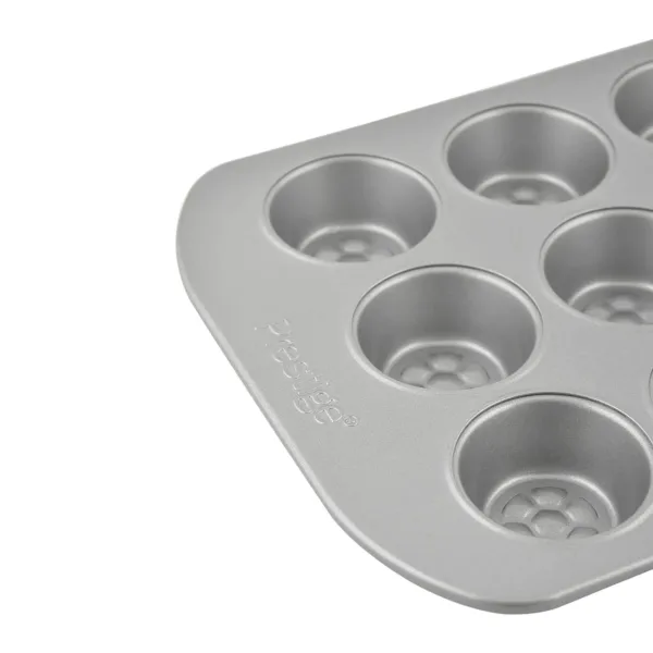 Bake delicious mini muffins with ease using the Prestige 12-cup muffin tin, featuring a nonstick surface, durable carbon steel construction, and a honeycomb base for even browning and easy release.