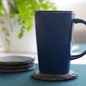 This set of four black slate coasters features a natural, rough-edged design, providing a rustic and stylish surface to protect furniture from drink spills and water rings in your kitchen, living room, or bar area.