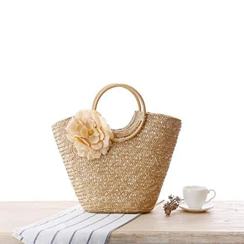 Off-white straw tote bag for women, perfect for summer, featuring a woven design and big flower accent, ideal as a beach bag or fashionable handbag.