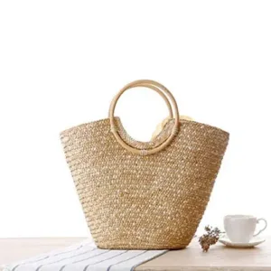 Off-white straw tote bag for women, perfect for summer, featuring a woven design and big flower accent, ideal as a beach bag or fashionable handbag.
