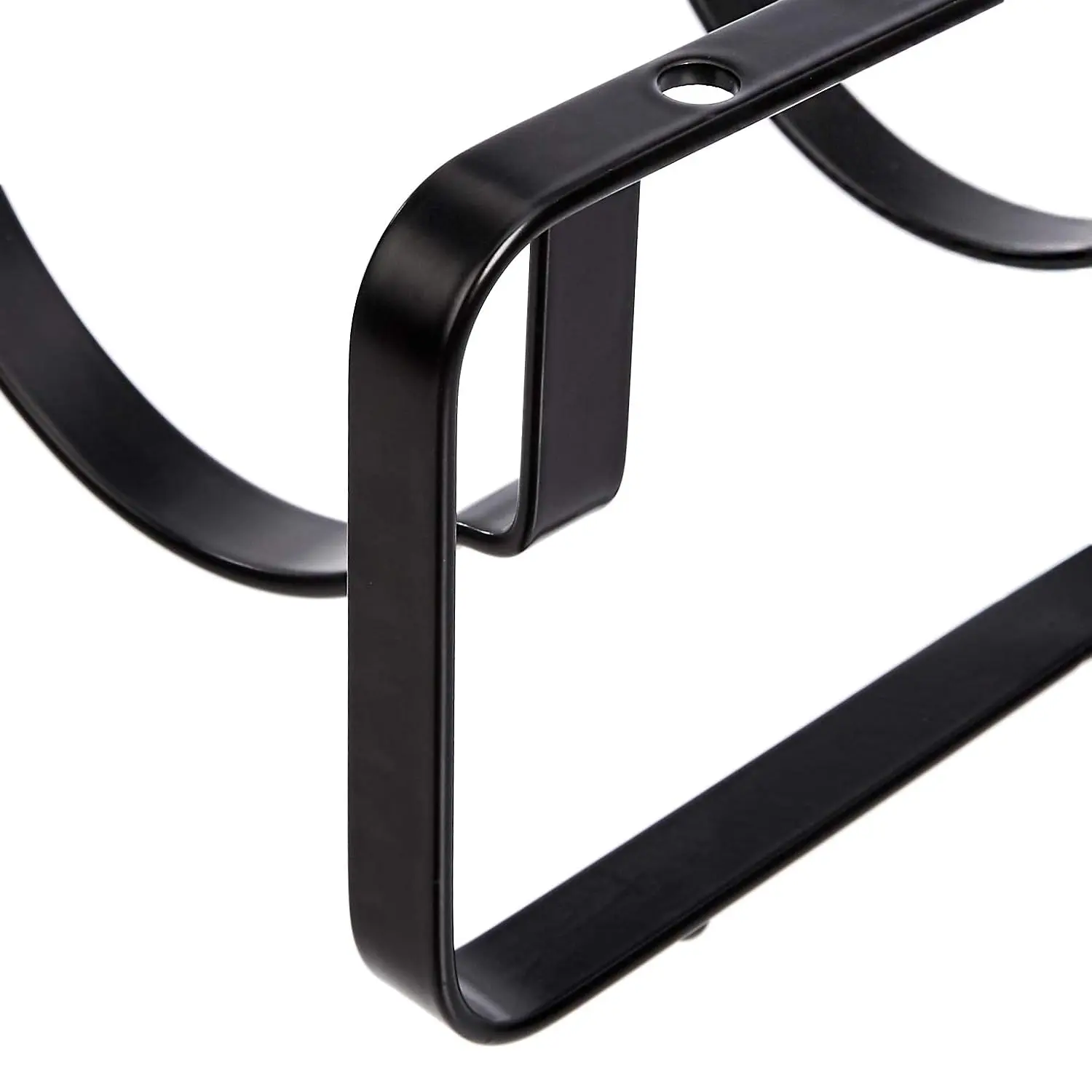 A stackable steel wine rack with a wave design securely holds wine bottles on a tabletop, preventing them from rolling.