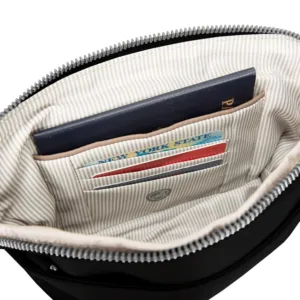 This Travelon anti-theft crossbody clutch bag can be worn as a wristlet or crossbody, featuring locking compartments, slash-resistant construction, RFID protection, and a built-in LED light.