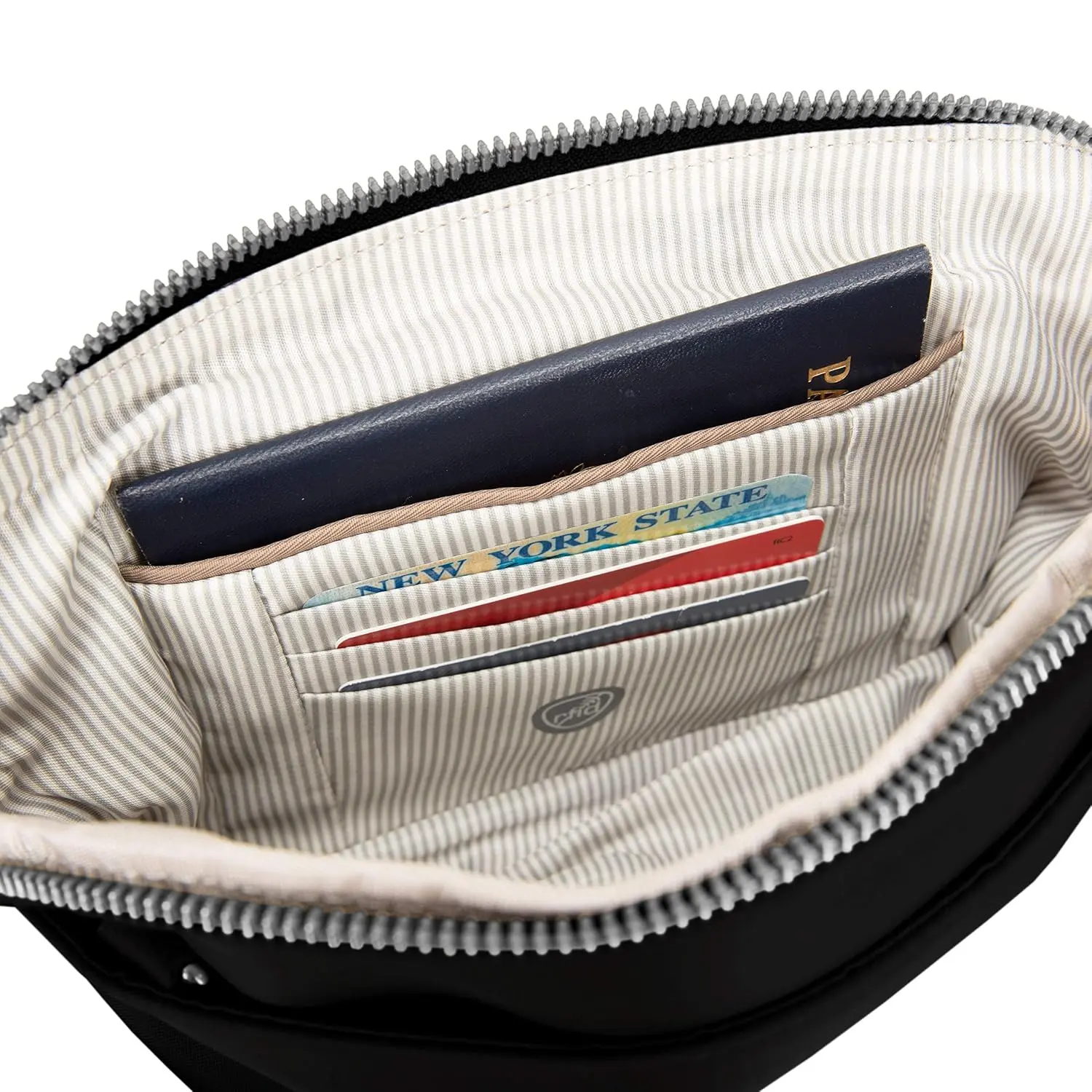 This Travelon anti-theft crossbody clutch bag can be worn as a wristlet or crossbody, featuring locking compartments, slash-resistant construction, RFID protection, and a built-in LED light.