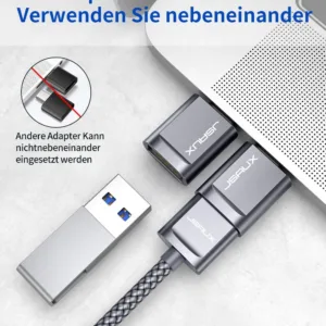 Two grey JSAUX USB-C to USB 3.0 OTG adapters plugged side-by-side into a MacBook Pro, demonstrating the offset design that allows simultaneous use with fast 5Gbps data transfer.