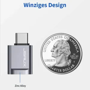 Two grey JSAUX USB-C to USB 3.0 OTG adapters plugged side-by-side into a MacBook Pro, demonstrating the offset design that allows simultaneous use with fast 5Gbps data transfer.