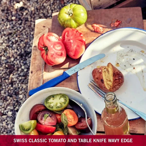A blue-handled Victorinox Swiss Classic tomato knife with a wavy edge is displayed, highlighting its precision and sharpness for effortless slicing.