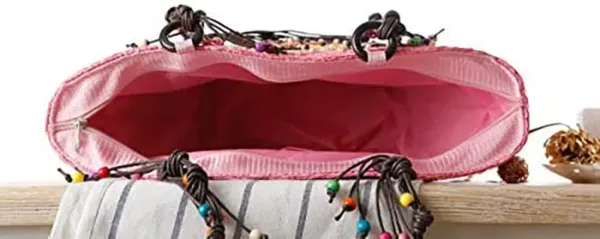 This is a handmade straw woven beach bag with embroidery and beading, perfect for women's fashion as a summer handbag or knitted tote.