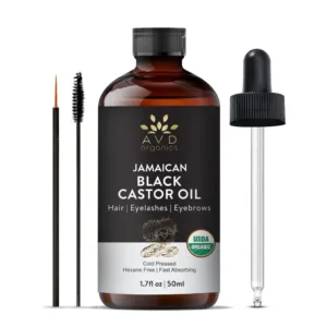 A bottle of AVD Organics Jamaican Black Castor Oil with dropper and lash brush, for moisturizing hair and skin and promoting eyelash and eyebrow growth.