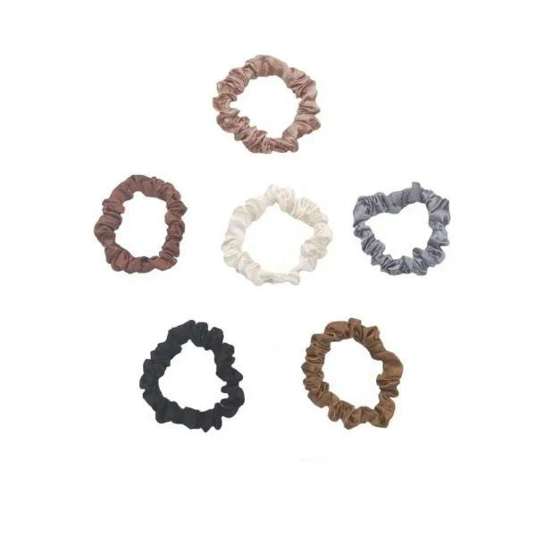 This set of six delicate silk hair scrunchies in assorted colors are soft, comfortable, and perfect for creating high buns, ponytails, half up hairstyles, or wearing as a stylish wrist accessory.