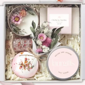 This small, luxurious Orchid & Jasmine spa gift box is a perfect self-care gift for women, including a soy candle, bath bomb, handmade soap, salt scrub, bath salts, and a mini dried flower bouquet, beautifully presented for any occasion.